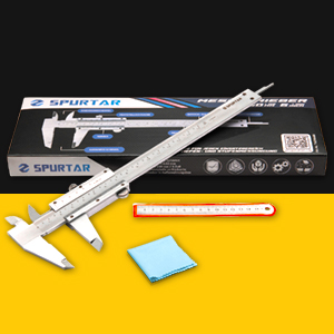 Metal vernier caliper with digital display on yellow surface, alongside packaging box and small accessories. Precision measurement tool for accurate dimensional measurements.