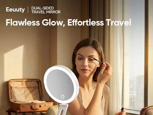 Woman applying mascara using eeuuty lighted travel mirror with warm hotel ambiance
