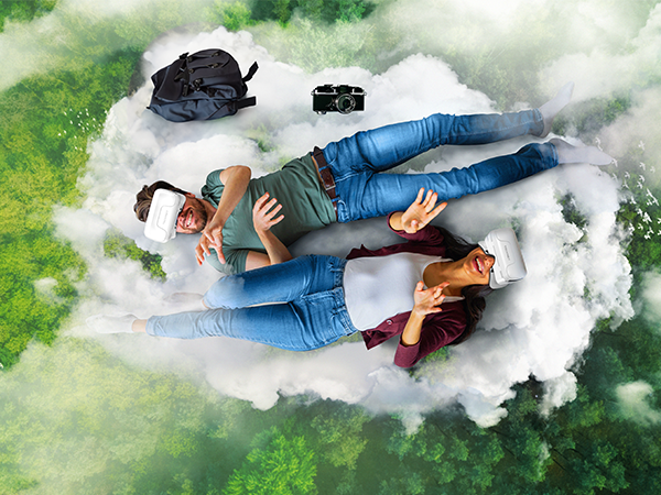 Aerial photography setup showing people lying on cloudy white backdrop with green background effects and photography equipment visible.