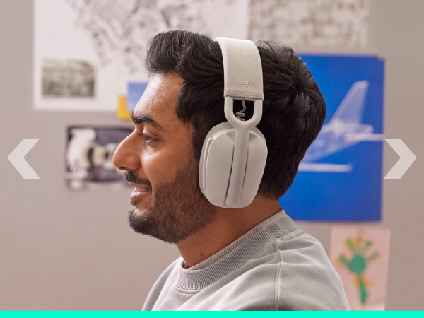 A man working on a computer and wearing Zone Vibe 100 (Off-White)