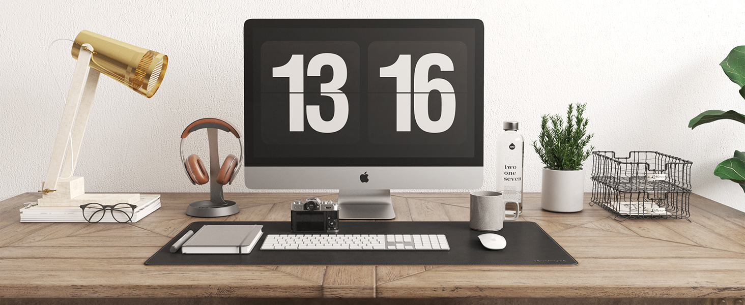 a large leather black mouse pad on the wood office desk, mouse pad for mouse and key board