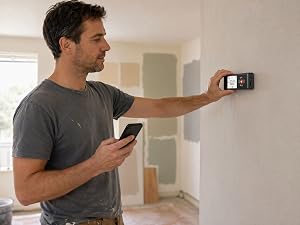 COROLLATA bilateral laser distance meter used by DIY homeowner measuring wall during renovation