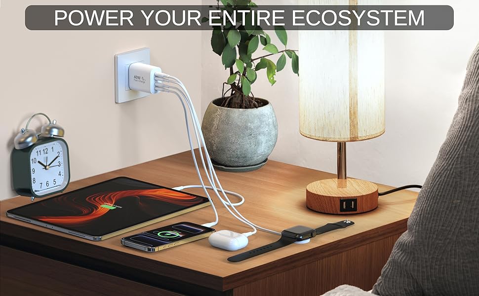 40W 4-port USB C fast charger block powering multiple devices on a nightstand.