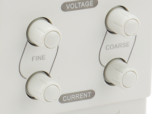 Control panel with four circular dials labeled 'Voltage', 'Fine', 'Coarse', and 'Current'. White background with raised tactile surface.