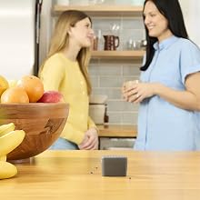 Image of home owners talking in the kitchen with the fly trap on the kitchen counter