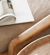 Close-up view of brown suede or leather material, partially visible with what appears to be white paper or fabric in the background.