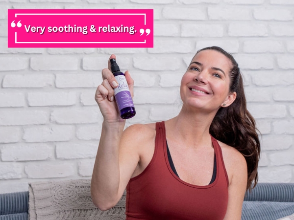 Woman using relax aromatherapy spray as a room spray.