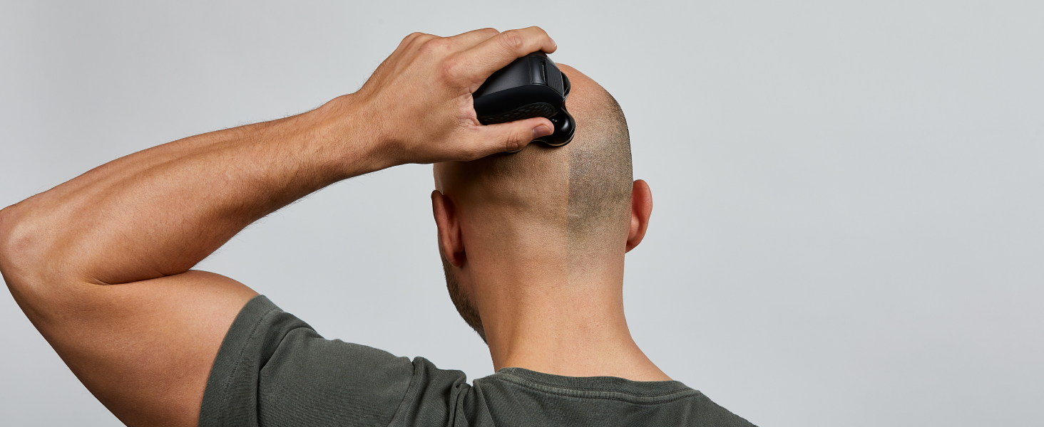 Man shaving head and face with a compact shaver