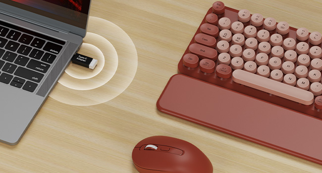 USB receiver plug in laptop connects wine red wireless keyboard mouse combo with wrist rest on desk