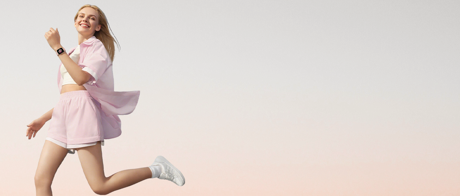 Person in light pink dress and white shoes jumping against a neutral gradient background, captured in dynamic mid-motion pose.