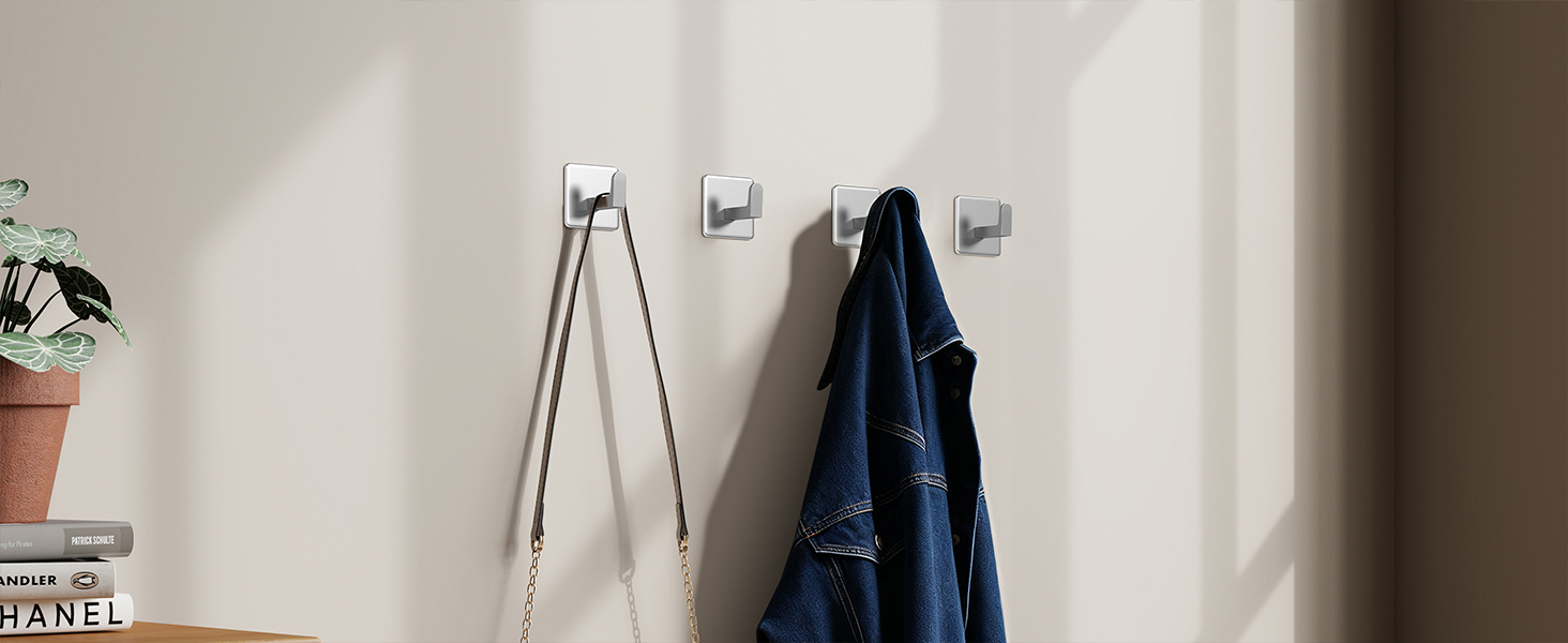 Wall-mounted bathroom accessories installation sequence. Shows mounting brackets and hardware being attached to white wall surface.