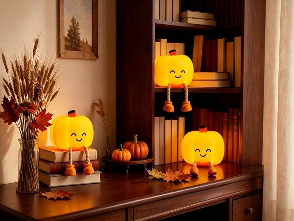 Pumpkin night lights on the bookshelf