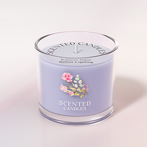 Lavender-colored scented candle in glass jar with floral design, labeled 'Scented Candle'.