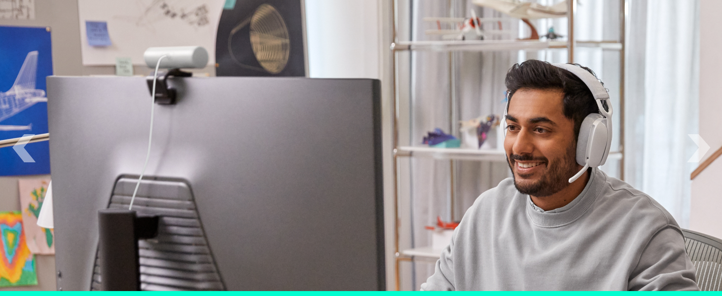 A man wearing Zone Vibe 100 (Off-White) and working on a computer