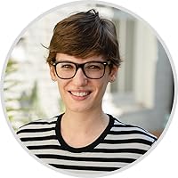 a woman with short hair and glasses smiles at the camera.