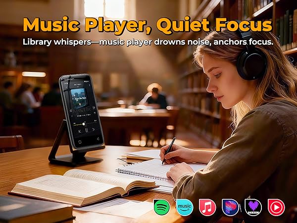Student wearing headphones studies in a quiet library with a Globluum MP3 player on a stand.