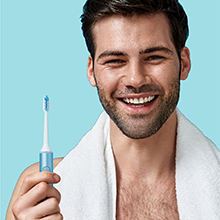 REACH, toothbrush, Man holding toothbrush, power toothbrush