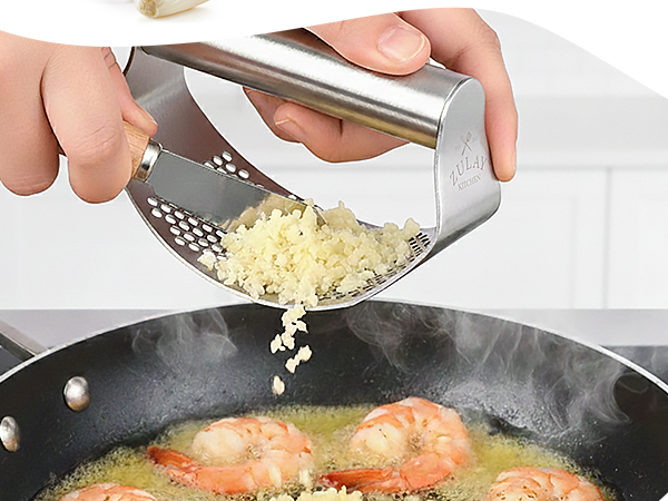 Manual garlic crusher rocker with stainless steel design for quick garlic mincing.