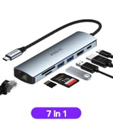 A slim, gray USB hub with multiple ports, including USB, HDMI, and card reader slots. Text indicates it's a 7-in-1 device.