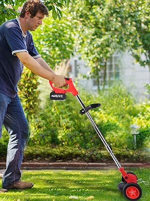 Man using a cordless electric grass trimmer with red wheels in a garden. The trimmer has an adjustable handle and is being operated on a lawn.