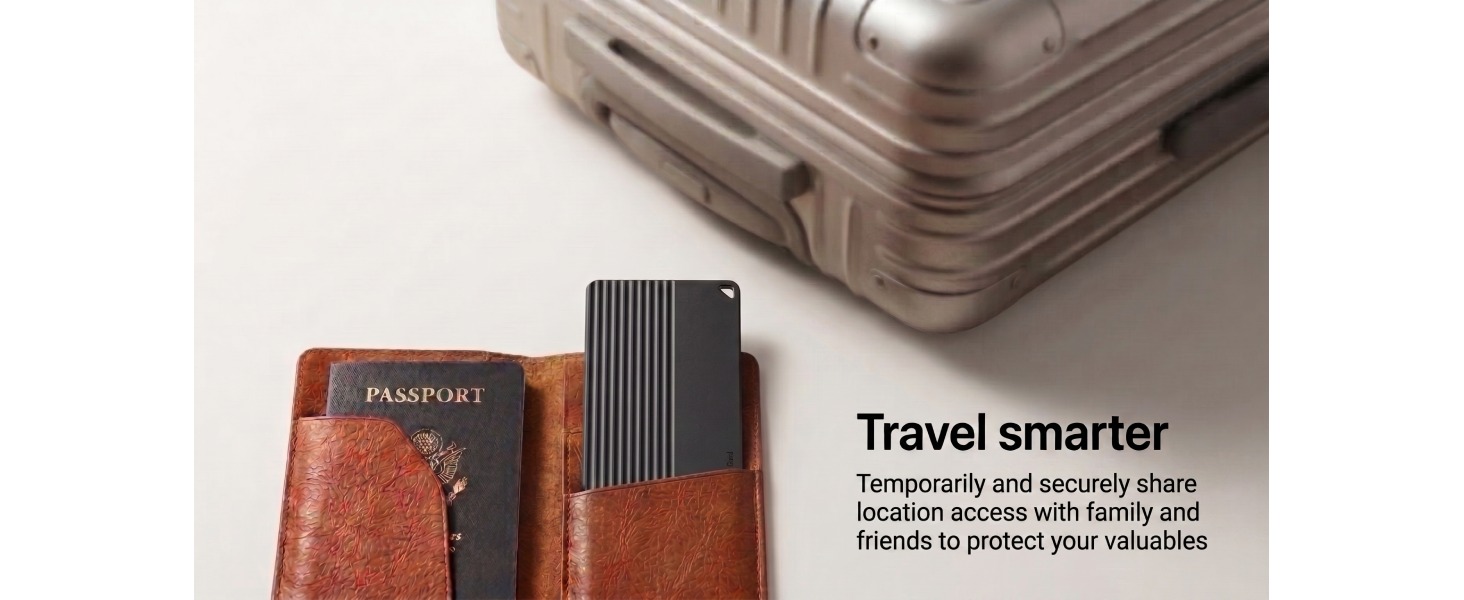 Slim tracker card placed beside a passport and travel suitcase.