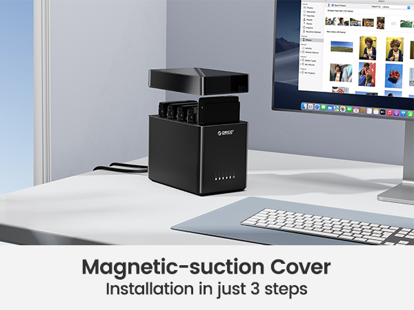 Black, cube-shaped device on desk next to computer setup. Text indicates it has a magnetic-suction cover installable in 3 steps.