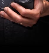 a close up of a person's hand holding a camera