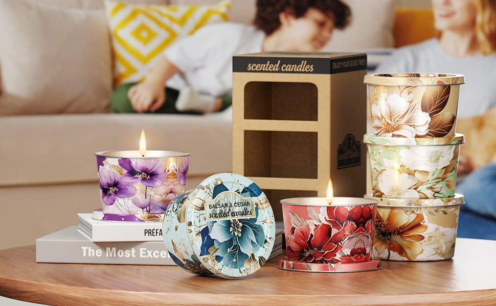 Text reads 'scented candles'. Display of decorative gel candles with embedded flowers in various colors including purple, blue, and red, arranged on wooden surfaces.