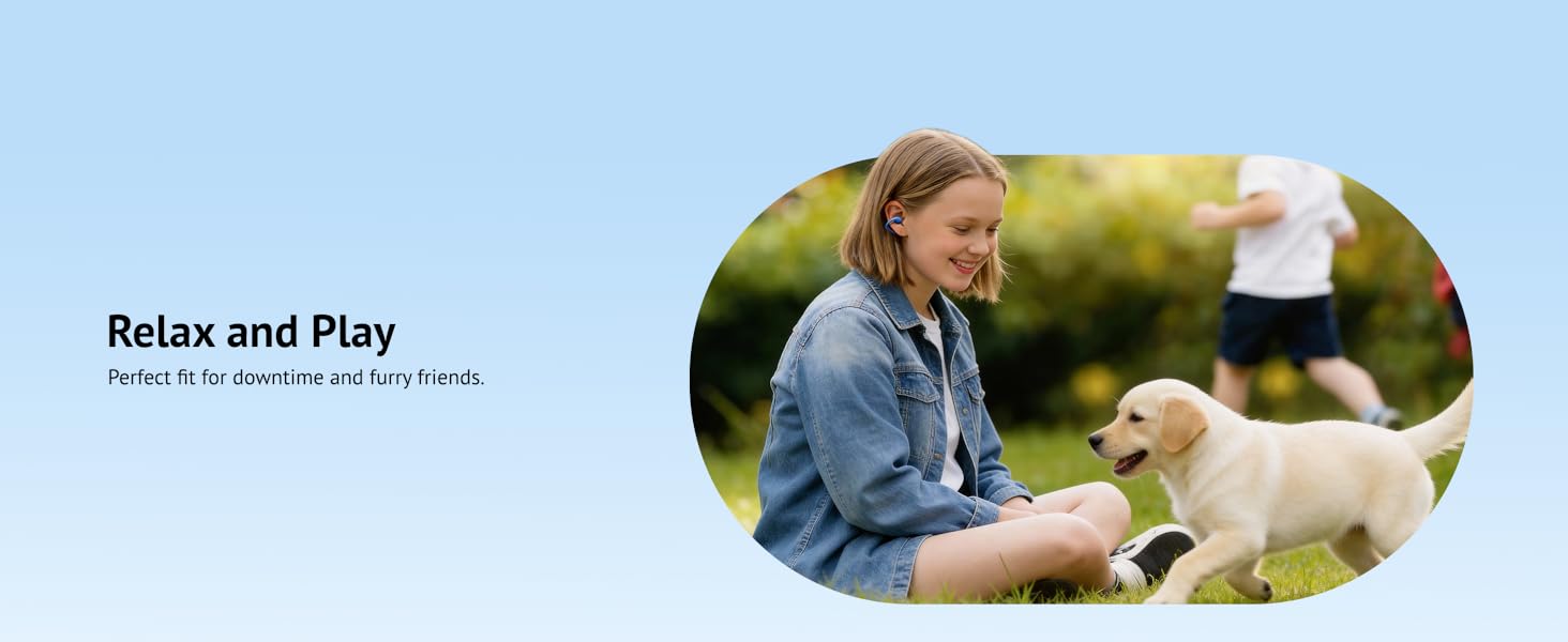 playing with dog in park wearing lightweight open-ear clip headphones compatible with glasses.