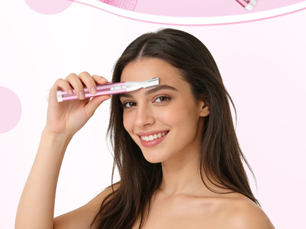 Woman using an electric eyebrow trimmer to shape her brows with a gentle motion