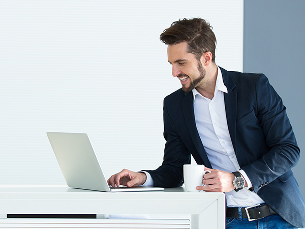 Series of photos showing someone in business attire working at a desk with a laptop in an office setting.