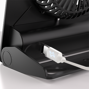 Close-up of a black grill or smoker showing a metal skewer attachment or tool inserted into a side port.