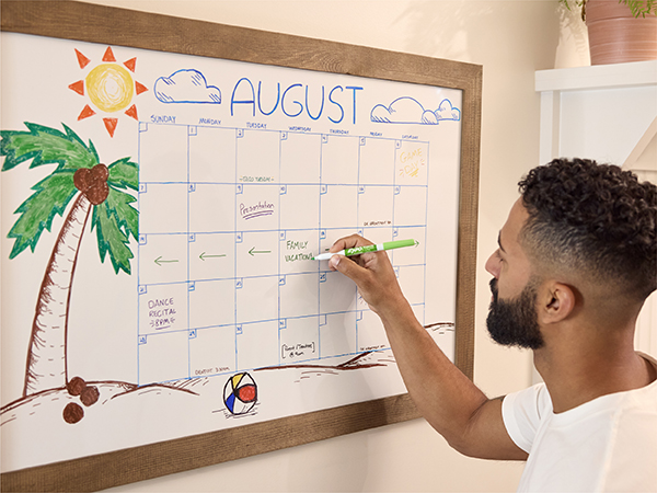 Guy writing into calendar dry erase