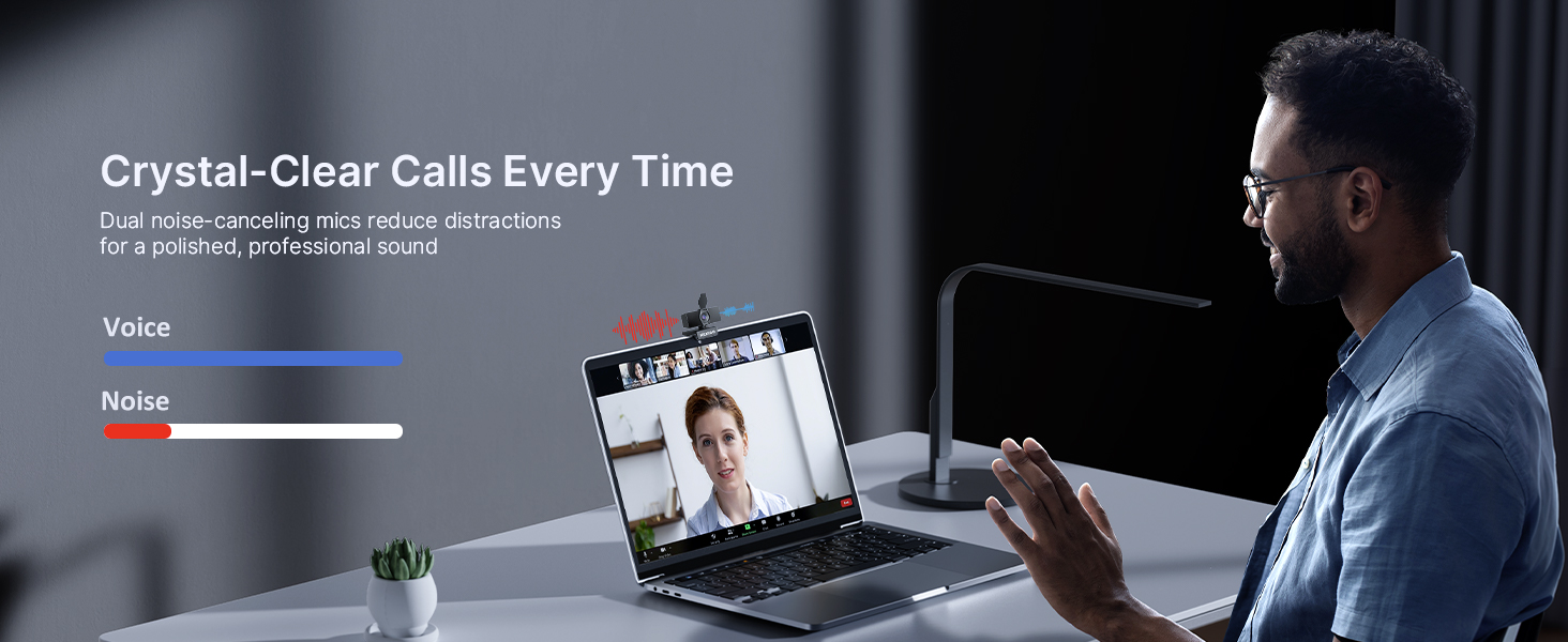 A man is attending a company video meeting using a noise-canceling microphone.