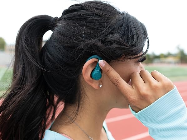 Woman using touch controls on jbuds sport
