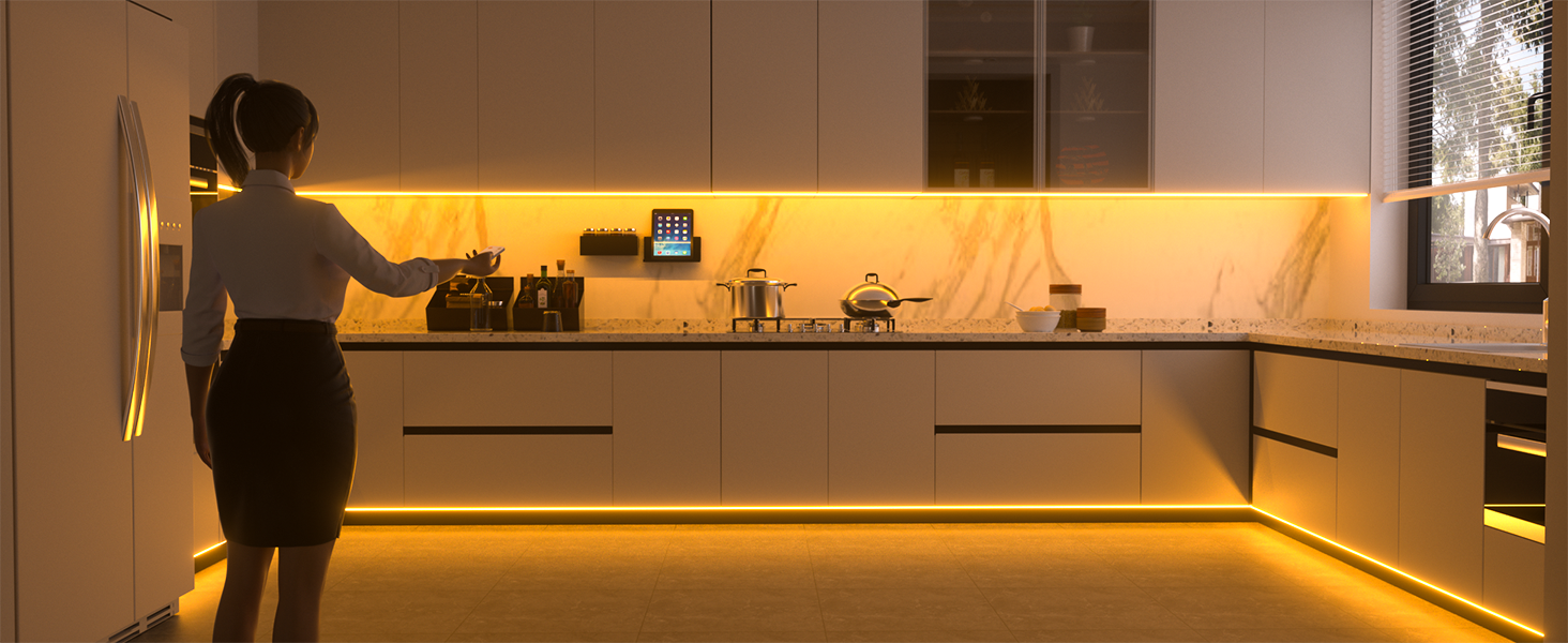 Modern kitchen with white cabinets and warm LED under-cabinet lighting creating an ambient glow along the L-shaped counter space.