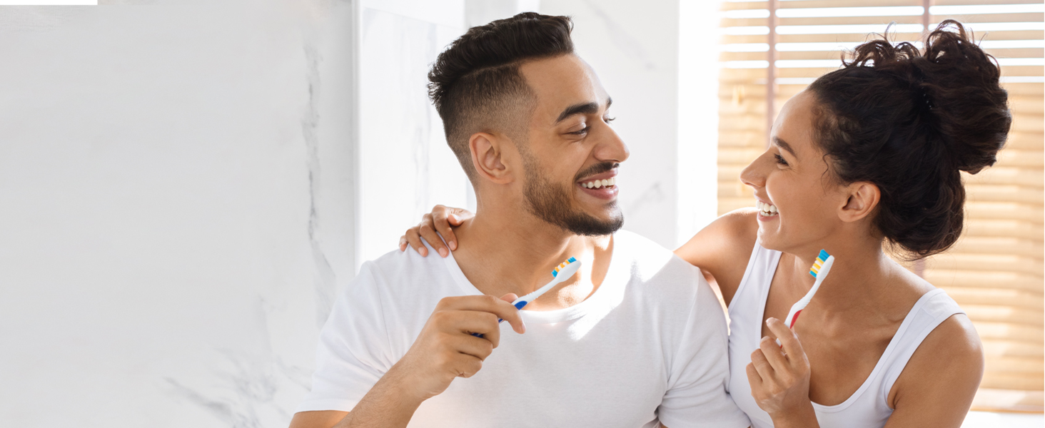 woman and man brushing teeth