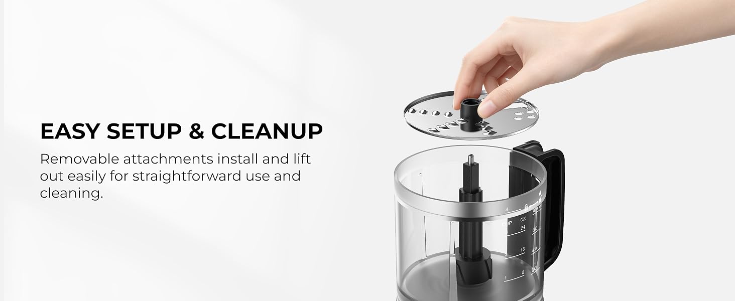 Hand holding the removable slicing and shredding disc above the 4-cup processor bowl.