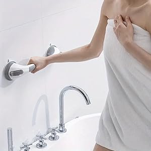 A serene bathroom interior with a glass shower enclosure, featuring elegant tile work and soft light