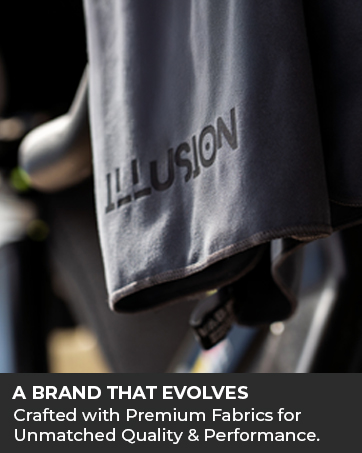 Close-up of light gray fabric with 'ILLUSION' text embossed. Garment appears to be athletic wear made from premium material, emphasizing quality and performance.