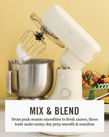 stand mixer with cookie dough inside, head tilted