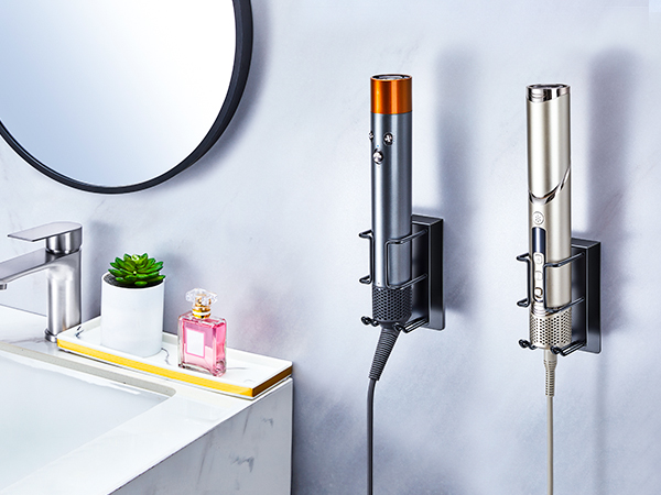 Collection of wall-mounted bathroom accessories including soap dispensers, towel holders, and storage solutions in metallic silver finish against white wall.