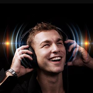 Over-ear headphones shown in use against dark background with colorful light effects, demonstrating audio experience.
