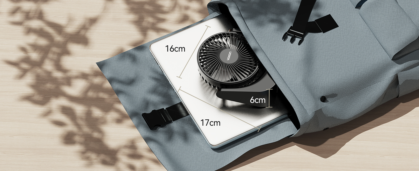 Open gray backpack showing interior compartments. Contains a small fan, laptop, and other items. Dimensions of 16cm, 6cm, and 17cm are labeled.