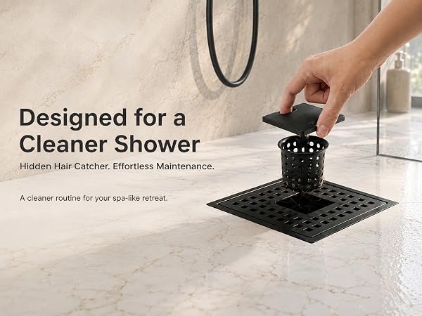 Hand lifting hidden hair catcher from matte black square shower drain in marble tile shower