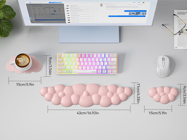 Ergonomic desk setup with colorful keyboard, white mouse, and pink cushioned wrist rests. Wrist rests shown in three sizes with measurements. Coffee cup and monitor visible.
