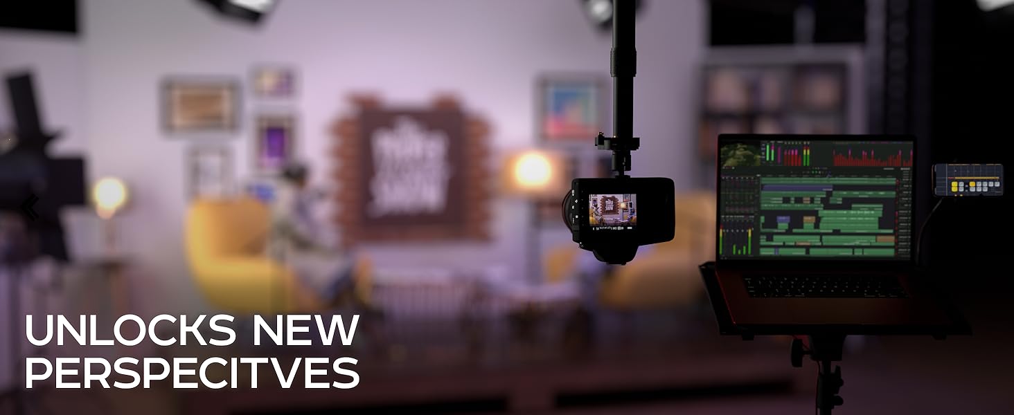 UNLOCKS NEW PERSPECTIVES; camera on pole beside laptop in studio setup.