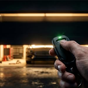 Remote controlling garage from driveway with car parked inside