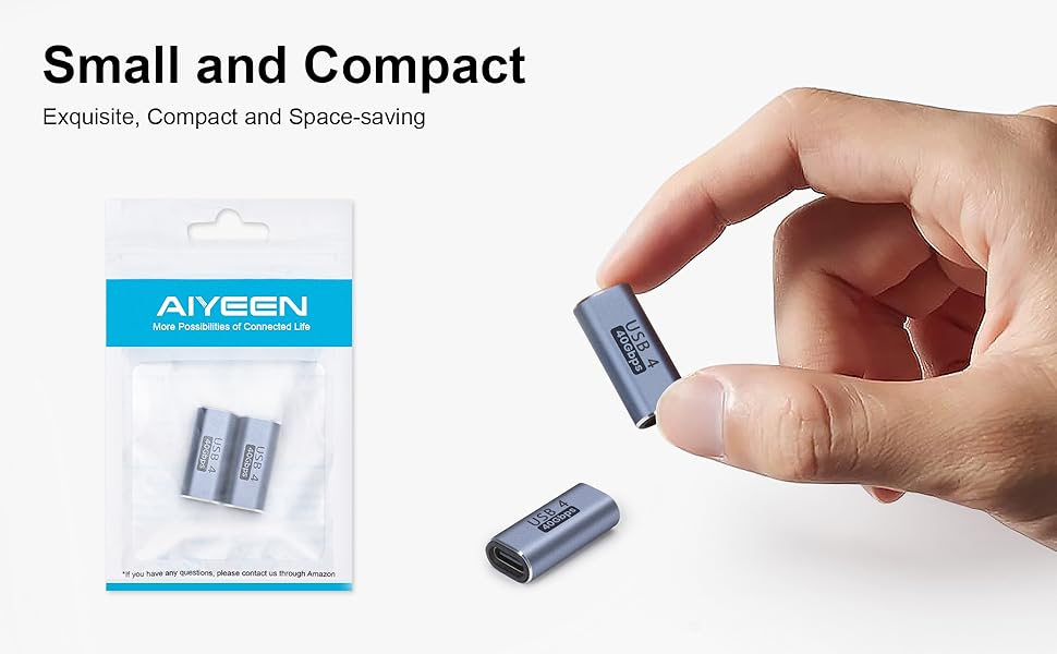 Small, compact USB adapters. Hand holding tiny gray device for scale. Packaging labeled 'AIYSEN' visible in background.