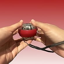 a person holding a red ball with a cord around it.